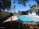 Inviting backyard oasis featuring a pool, fence, and landscaped surroundings at 1531 W Naranja Ave, Mesa, AZ 85202