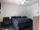 This bedroom features a ceiling fan, dark wood floors and neutral walls at 1531 W Naranja Ave, Mesa, AZ 85202