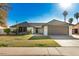 Attractive one-story home with a manicured lawn, palm trees, and an attached garage at 1531 W Naranja Ave, Mesa, AZ 85202