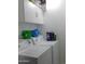 Practical laundry room with washer, dryer, storage cabinets, and utility supplies at 1531 W Naranja Ave, Mesa, AZ 85202