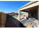 View of the backyard with covered patio, gazebo, turf area, and desert landscaping at 17531 W Hedgehog Pl, Surprise, AZ 85387