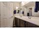 Bathroom featuring a double vanity with modern fixtures and a well lit mirror at 17531 W Hedgehog Pl, Surprise, AZ 85387