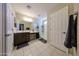 Bathroom featuring a double vanity, framed mirror, walk-in shower and neutral tile floor at 17531 W Hedgehog Pl, Surprise, AZ 85387