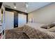 Stylish bedroom featuring a chalkboard wall, carpet, and modern ceiling fan at 17531 W Hedgehog Pl, Surprise, AZ 85387