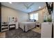 This bedroom features carpet, neutral walls and a ceiling fan at 17531 W Hedgehog Pl, Surprise, AZ 85387