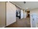 Hallway view with sliding barn doors opening to a bedroom, showcasing its decor and ample natural light at 17531 W Hedgehog Pl, Surprise, AZ 85387