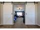 Bedroom entrance featuring sliding barn doors that open to the decorated ' room, with a vanity and play tent at 17531 W Hedgehog Pl, Surprise, AZ 85387