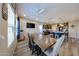 Spacious dining area with a large wooden table, seating for six, and a view into the modern kitchen at 17531 W Hedgehog Pl, Surprise, AZ 85387