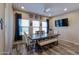 Bright dining room featuring a wooden table, upholstered chairs, a bench, a ceiling fan, and 'EAT' wall decor at 17531 W Hedgehog Pl, Surprise, AZ 85387