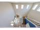 Elevated view of the entryway with soaring ceilings, a staircase, and wood-look flooring leading to other rooms at 17531 W Hedgehog Pl, Surprise, AZ 85387