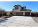 Lovely two-story home with a 3-car garage, desert landscaping, and shuttered windows at 17531 W Hedgehog Pl, Surprise, AZ 85387