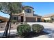 Attractive neutral stucco home with desert landscaping and a spacious driveway leading to a 3-car garage at 17531 W Hedgehog Pl, Surprise, AZ 85387