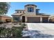 Beautiful two-story home featuring a neutral stucco exterior, 3-car garage, and well-manicured desert landscaping at 17531 W Hedgehog Pl, Surprise, AZ 85387