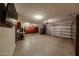 Spacious garage featuring an epoxy floor, built-in cabinets, and a refrigerator at 17531 W Hedgehog Pl, Surprise, AZ 85387