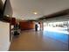 Well-organized garage with epoxy floor, built-in cabinets, and a stainless steel refrigerator at 17531 W Hedgehog Pl, Surprise, AZ 85387