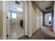 This hallway provides access to the laundry room and has neutral walls and carpet at 17531 W Hedgehog Pl, Surprise, AZ 85387