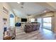 Cozy living room featuring comfortable seating, built-in shelving, and sliding door access to the patio at 17531 W Hedgehog Pl, Surprise, AZ 85387