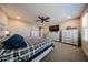 This bedroom features neutral walls, carpet, a ceiling fan and a wall-mounted TV at 17531 W Hedgehog Pl, Surprise, AZ 85387