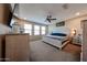 This bedroom features neutral walls, carpet, and natural light from three windows at 17531 W Hedgehog Pl, Surprise, AZ 85387