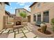 Beautiful backyard with a stone fireplace, water feature, and lush landscaping, creating a serene outdoor space at 17727 N 95Th Pl, Scottsdale, AZ 85255