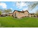 Expansive backyard featuring lush green grass, mature trees, and meticulous landscaping for outdoor enjoyment at 17727 N 95Th Pl, Scottsdale, AZ 85255