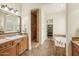 Spacious bathroom featuring a walk-in shower, soaking tub, and dual sinks with wood cabinetry at 17727 N 95Th Pl, Scottsdale, AZ 85255