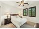 Well-lit bedroom with ceiling fan, dark wood furniture, and plantation shutters at 17727 N 95Th Pl, Scottsdale, AZ 85255