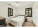 Cozy bedroom with dual windows, each fitted with dark shutters and carpeted floors at 17727 N 95Th Pl, Scottsdale, AZ 85255