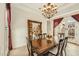 Bright dining room featuring wood table, chairs, chandelier, large painting, and access to the patio at 17727 N 95Th Pl, Scottsdale, AZ 85255