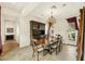 Elegant dining room with a chandelier, dark wood table, and matching china cabinet at 17727 N 95Th Pl, Scottsdale, AZ 85255