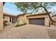 Exterior view of house featuring an oversized two-car garage and paved driveway at 17727 N 95Th Pl, Scottsdale, AZ 85255