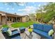 Cozy outdoor living area with comfortable seating and vibrant floral accents in a beautifully landscaped backyard at 17727 N 95Th Pl, Scottsdale, AZ 85255