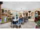 Formal dining room with a large table, chandelier, and unique decor at 18835 N Mayan Dr, Sun City, AZ 85373