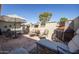 Beautiful outdoor patio featuring brick pavers, seating arrangements, and stylish decor at 18835 N Mayan Dr, Sun City, AZ 85373