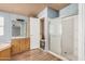 Standard bathroom with a tub, shower and wooden cabinets at 19954 W Teepee Rd, Buckeye, AZ 85326