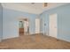 Cozy bedroom featuring two entrance doors and carpet at 19954 W Teepee Rd, Buckeye, AZ 85326