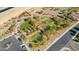 Aerial view of a well-designed neighborhood park featuring walking paths, playgrounds, and open green spaces at 21232 N 262Nd Dr, Buckeye, AZ 85396