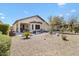 Expansive backyard with a covered patio, desert landscaping, and multiple seating areas for relaxation at 21232 N 262Nd Dr, Buckeye, AZ 85396