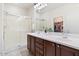 Stylish bathroom features double sinks, a shower, and a walk-in closet at 21232 N 262Nd Dr, Buckeye, AZ 85396