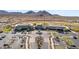 Aerial view of the clubhouse with its well-maintained grounds, ample parking, and desert mountain views at 21232 N 262Nd Dr, Buckeye, AZ 85396