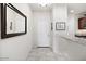 Welcoming entryway with neutral tones, a large mirror, and tile flooring at 21232 N 262Nd Dr, Buckeye, AZ 85396