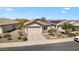 Charming single-story home with a well-maintained front yard, desert landscaping, and a two-car garage at 21232 N 262Nd Dr, Buckeye, AZ 85396