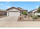 Well-maintained front exterior featuring desert landscaping, a two-car garage, and a welcoming entrance at 21232 N 262Nd Dr, Buckeye, AZ 85396