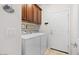 Functional laundry room with a washer, dryer, and plenty of cabinet space at 21232 N 262Nd Dr, Buckeye, AZ 85396