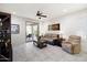 Living room with tile flooring, ceiling fan, and sliding glass door to the patio at 21232 N 262Nd Dr, Buckeye, AZ 85396