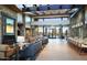 Inviting living room featuring stone accents, a cozy fireplace, and bright, open floor plan at 21232 N 262Nd Dr, Buckeye, AZ 85396