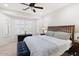 Relaxing main bedroom with a ceiling fan and a large window letting in natural light at 21232 N 262Nd Dr, Buckeye, AZ 85396