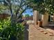 An enclosed backyard features a charming brick pathway and raised garden beds at 24809 N 41 Ave, Glendale, AZ 85310