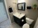 Bathroom with a modern vanity, decorative mirror, and tiled flooring at 24809 N 41 Ave, Glendale, AZ 85310