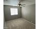 A well-lit bedroom features neutral walls, a ceiling fan, and a large window at 24809 N 41 Ave, Glendale, AZ 85310